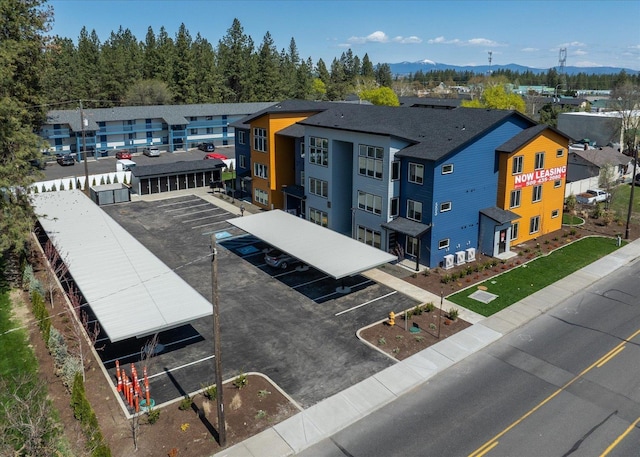 drone / aerial view featuring a residential view and a mountain view