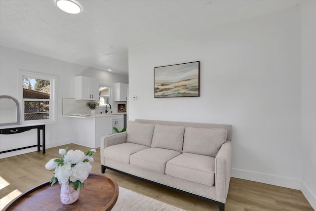 3903 E Hartson Ave, Spokane, WA 99202 - living room with baseboards and light wood-type flooring