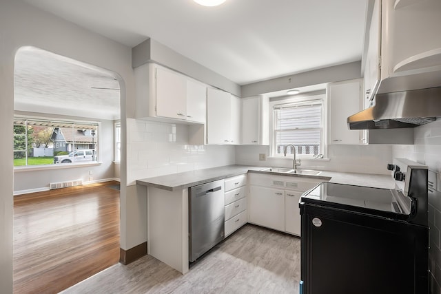 kitchen with electric range, a sink, dishwasher, island range hood, and visible vents