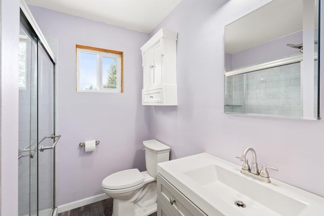 362 Panorama Dr, Newport, WA 99156 - full bath with vanity, wood finished floors, toilet, baseboards, and tiled shower