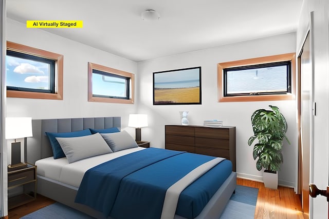 bedroom featuring baseboards and wood finished floors