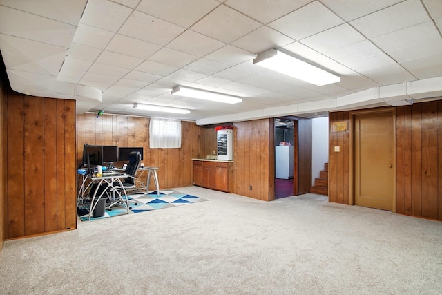 unfurnished office featuring carpet and wood walls