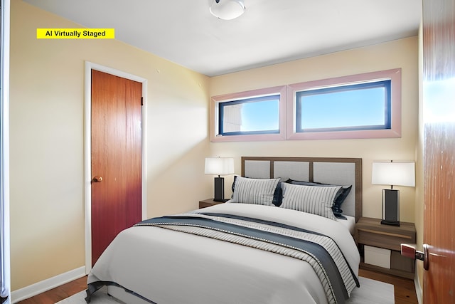 bedroom featuring baseboards and wood finished floors