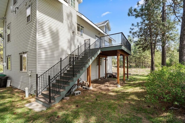 view of side of property featuring a wooden deck and stairway