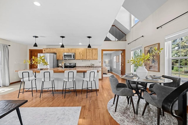 interior space featuring light wood-style floors, baseboards, and recessed lighting