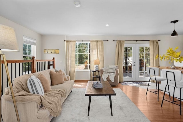 living area featuring recessed lighting, french doors, and light wood-style flooring