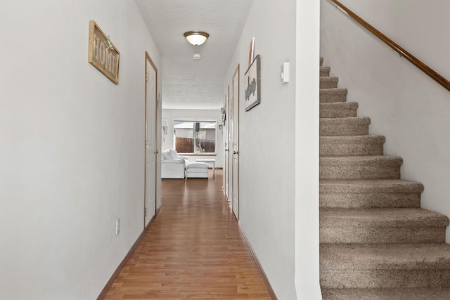 3713 S Harrison St, Spokane, WA 99224 - hallway with baseboards, stairs, and light wood-style flooring