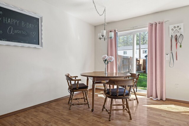 3713 S Harrison St, Spokane, WA 99224 - dining room with baseboards, wood finished floors, and a chandelier