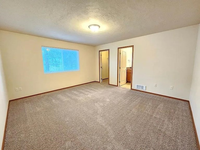 3713 S Harrison St, Spokane, WA 99224 - unfurnished bedroom featuring visible vents, a textured ceiling, carpet, and baseboards