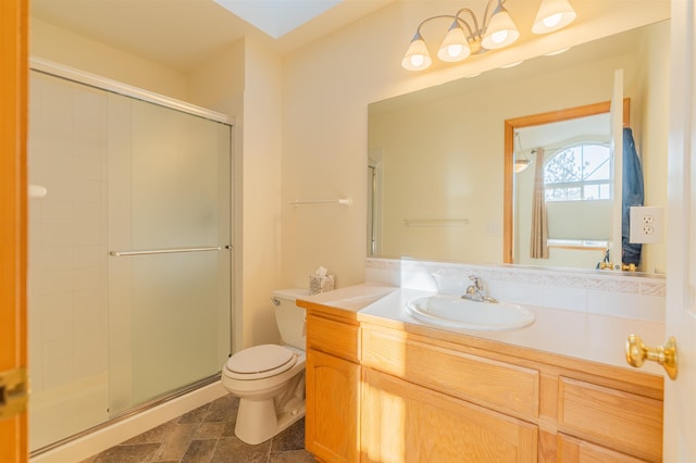 bathroom featuring vanity, a stall shower, and toilet