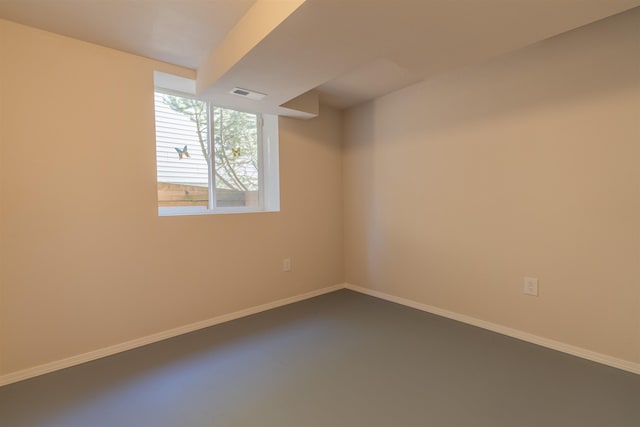 unfurnished room featuring visible vents and baseboards