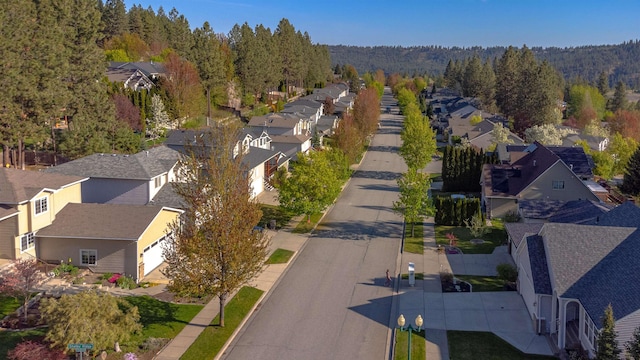 birds eye view of property with a forest view and a residential view