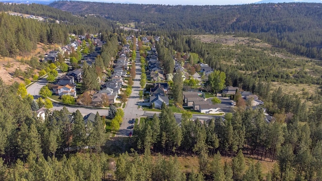 birds eye view of property with a view of trees, a residential view, and a mountain view