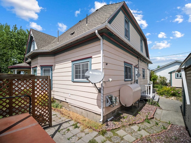 218 S Broadway St, Tekoa, WA 99033 - view of home's exterior featuring roof with shingles and oil tank
