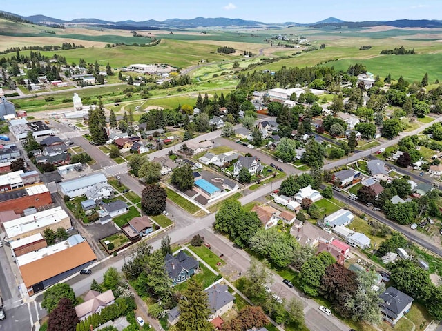 218 S Broadway St, Tekoa, WA 99033 - aerial view of property and surrounding area featuring a mountain backdrop and nearby suburban area