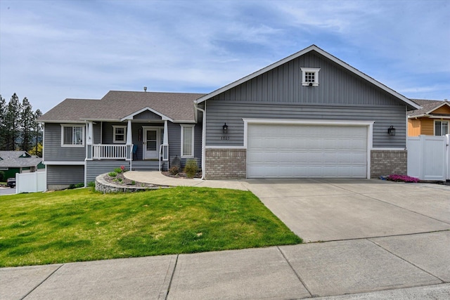 6805 Royal Ln, Spokane, WA 99208 - view of front of property featuring brick siding, a garage, concrete driveway, and covered porch