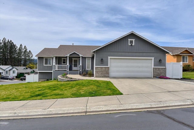 6805 Royal Ln, Spokane, WA 99208 - view of front of home with a garage, driveway, brick siding, and covered porch