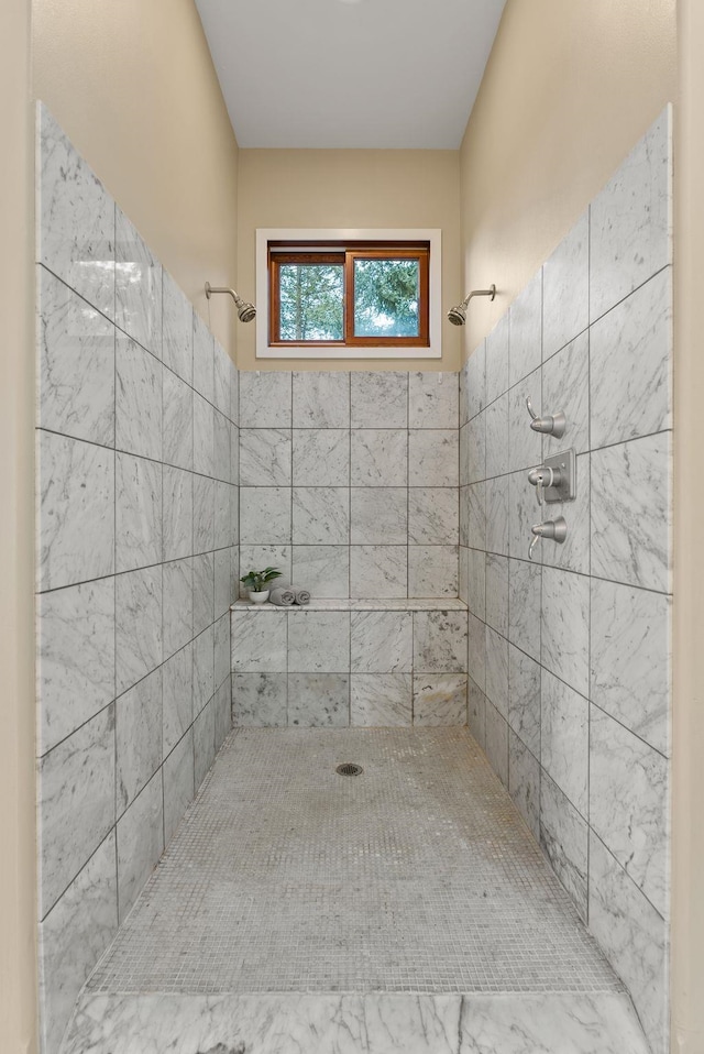 bathroom with a tile shower
