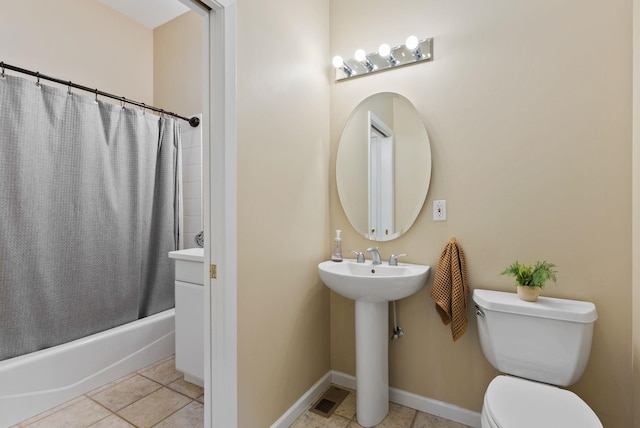 bathroom featuring visible vents, tile patterned flooring, a sink, toilet, and shower / tub combo with curtain