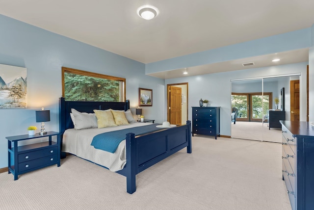 bedroom with baseboards, visible vents, and light carpet