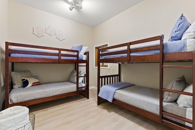bedroom with baseboards and wood finished floors