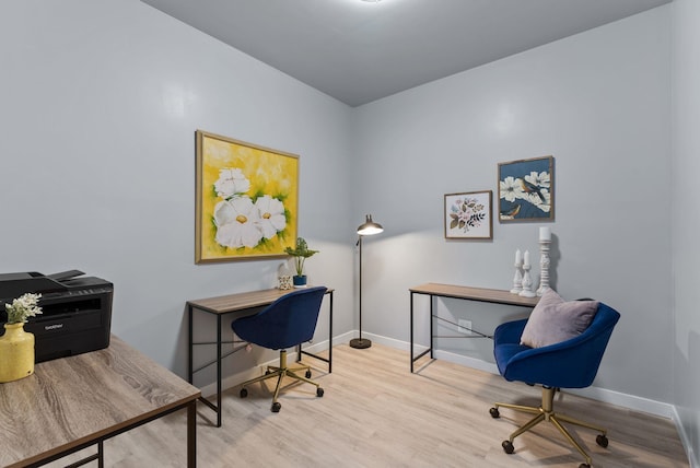 home office featuring baseboards and wood finished floors