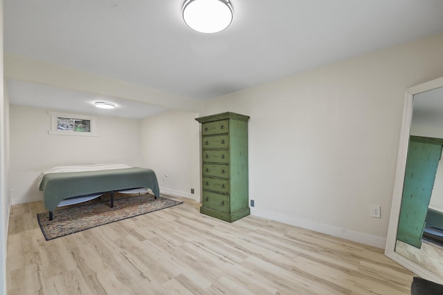 bedroom with baseboards and light wood-style floors