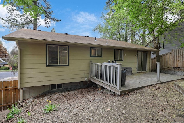 back of property featuring fence and a wooden deck