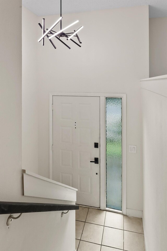 foyer entrance with baseboards and light tile patterned flooring