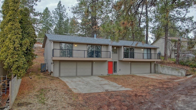 2514 E Casper Dr, Spokane, WA 99223 - view of front of house with central AC unit, an attached garage, concrete driveway, and a balcony