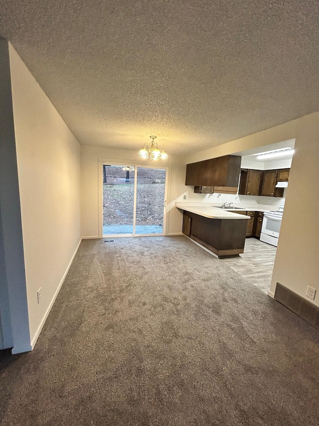 2514 E Casper Dr, Spokane, WA 99223 - interior space with light colored carpet, a notable chandelier, a sink, a textured ceiling, and baseboards