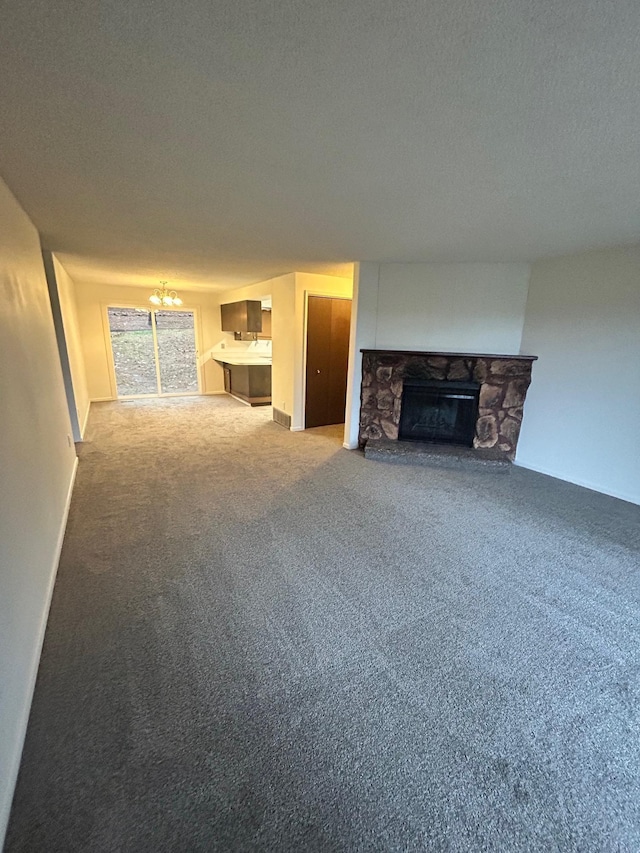 2514 E Casper Dr, Spokane, WA 99223 - unfurnished living room with carpet flooring, a textured ceiling, a notable chandelier, and a stone fireplace