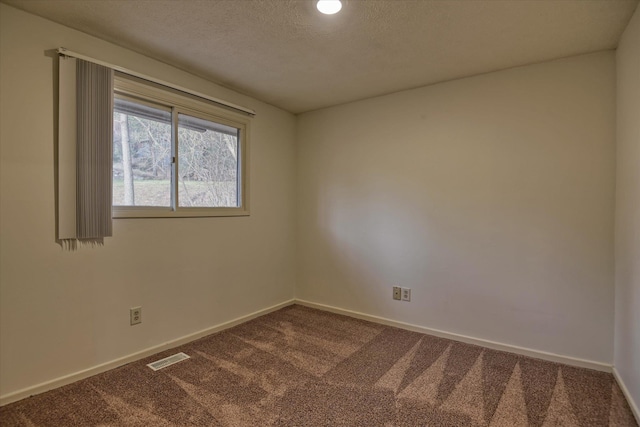 2514 E Casper Dr, Spokane, WA 99223 - empty room featuring baseboards, dark colored carpet, a textured ceiling, and visible vents