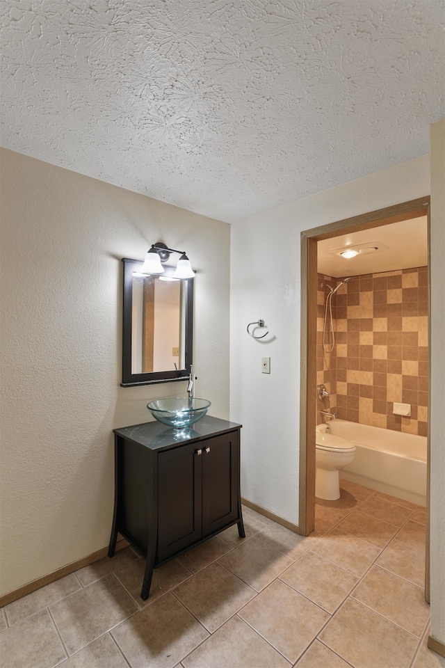 full bathroom featuring a textured ceiling, washtub / shower combination, tile patterned floors, and toilet