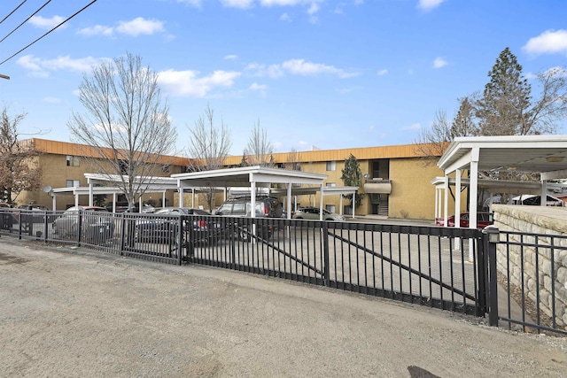 view of front facade featuring fence and a carport