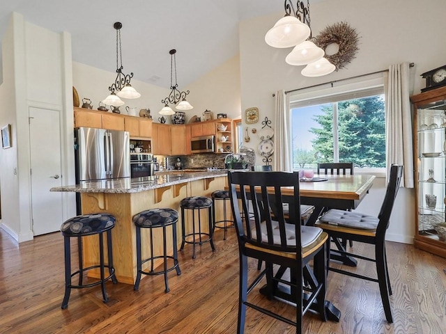 dining space with high vaulted ceiling, baseboards, and dark wood-style flooring