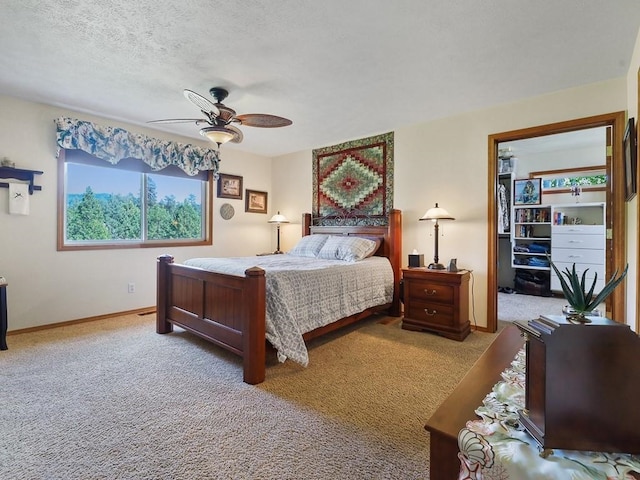 bedroom featuring carpet floors, a textured ceiling, ceiling fan, and baseboards