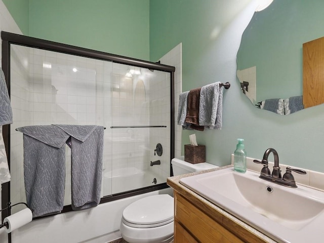 full bathroom with vanity, toilet, and shower / bath combination with glass door