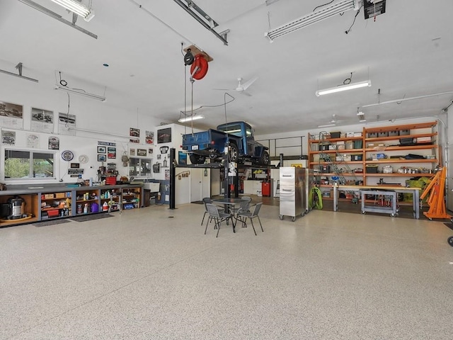 garage with a workshop area and a garage door opener