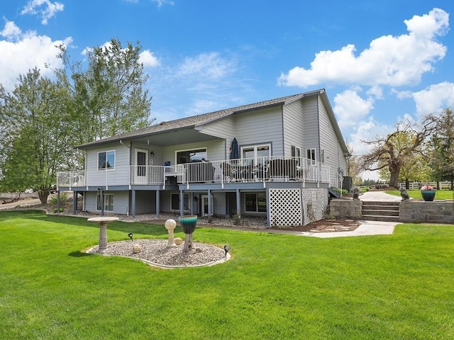 rear view of property featuring a lawn and a deck