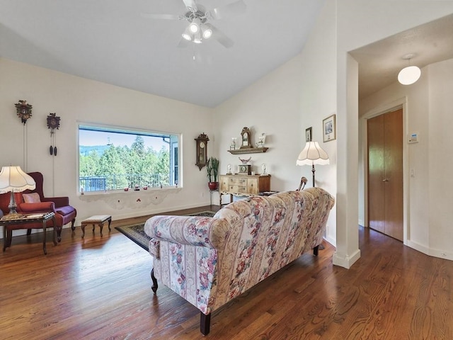 living area featuring baseboards, ceiling fan, wood finished floors, and lofted ceiling