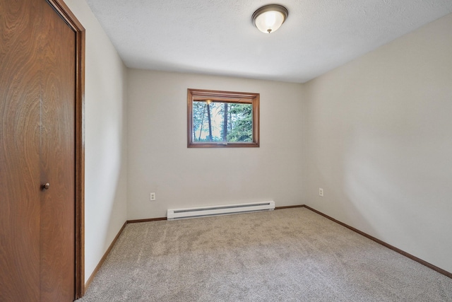 unfurnished bedroom with carpet flooring, a closet, baseboards, and a baseboard radiator