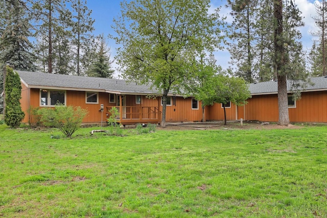 rear view of property with a yard