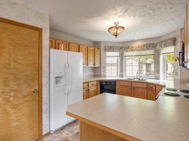 8409 N Pine Meadows Ln, Nine Mile Falls, WA 99026 - kitchen featuring a peninsula, white refrigerator with ice dispenser, light countertops, a textured ceiling, and a sink