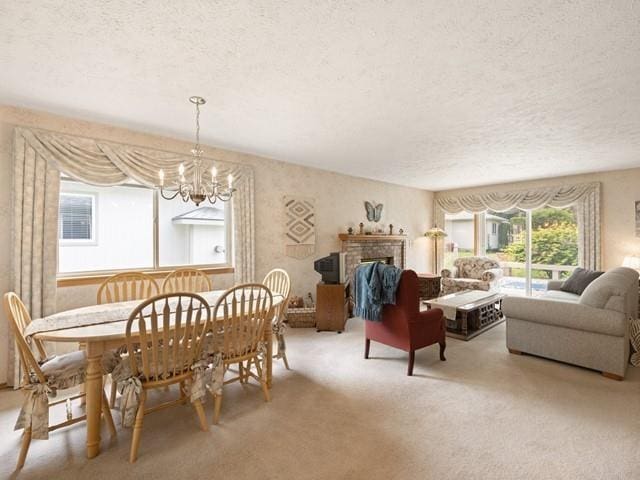 8409 N Pine Meadows Ln, Nine Mile Falls, WA 99026 - dining area with an inviting chandelier, carpet, a fireplace, and a textured ceiling