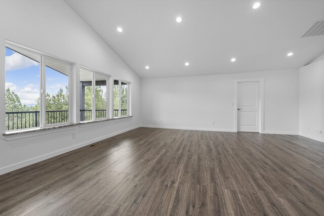 empty room with recessed lighting, dark wood finished floors, vaulted ceiling, and visible vents