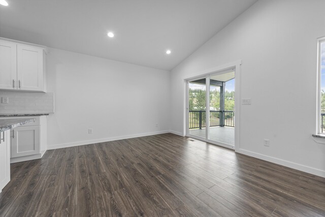 unfurnished living room featuring a healthy amount of sunlight, baseboards, dark wood-style flooring, and recessed lighting
