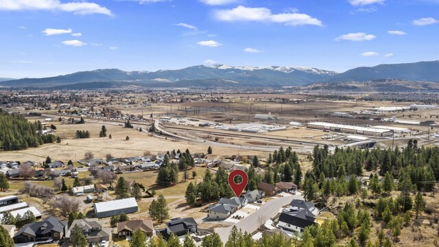 birds eye view of property with a mountain view