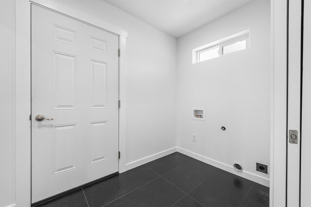 laundry room featuring dark tile patterned flooring, washer hookup, baseboards, and laundry area