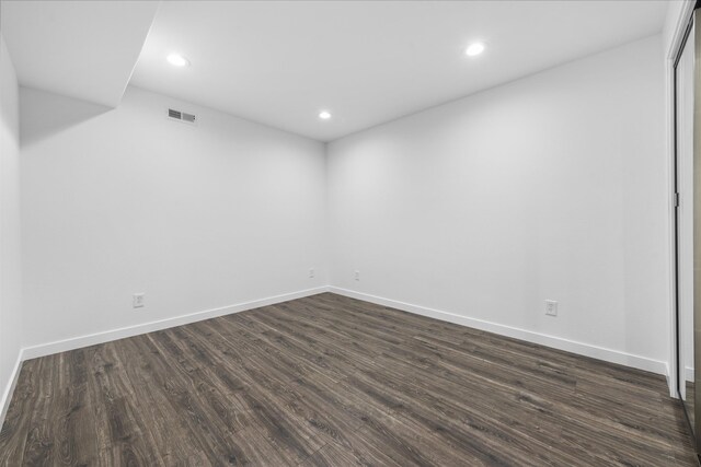 unfurnished room with visible vents, recessed lighting, dark wood finished floors, and baseboards